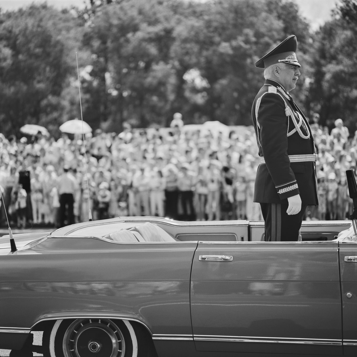 General of the Belarusian army in the car welcomes soldiers and participants of the victory procession, black-and-white film street photo