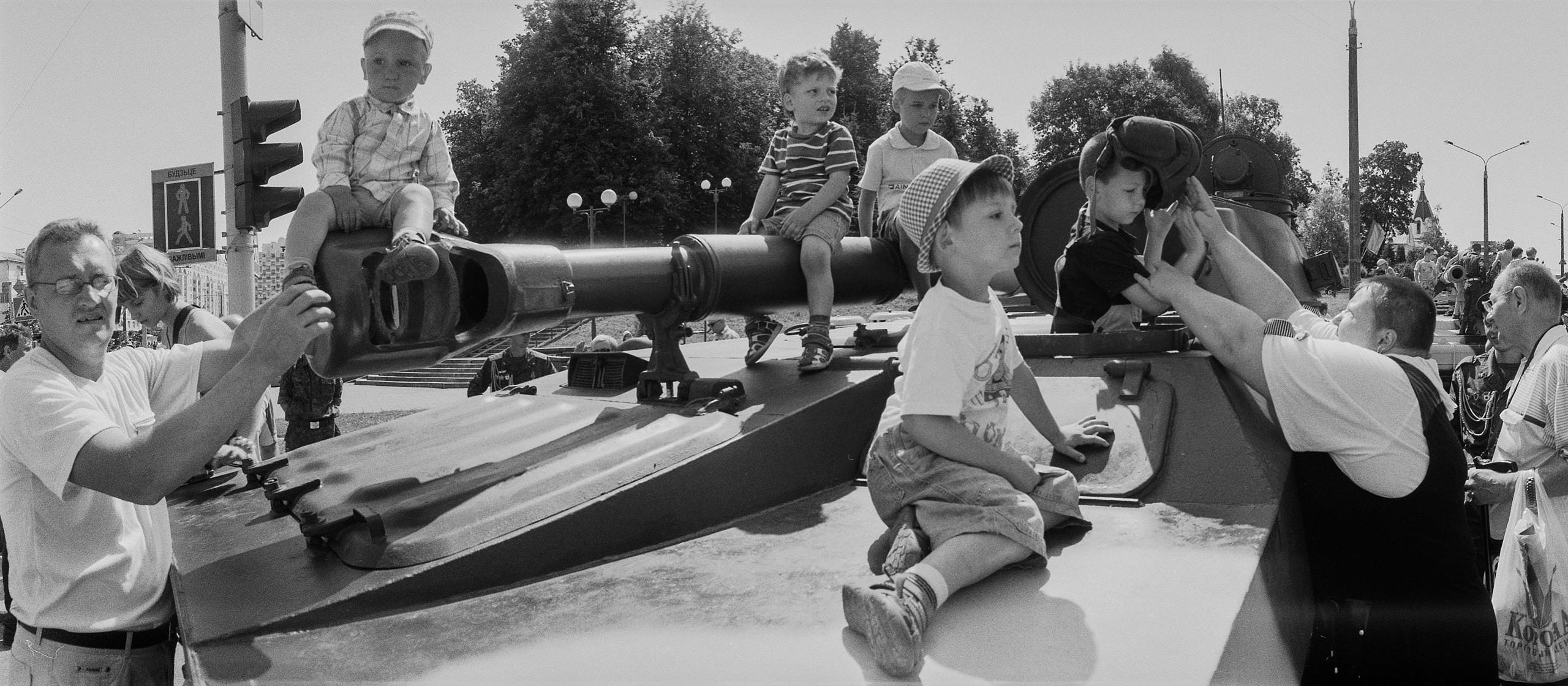 Small children playing on a tank after the military parade dedicated to the Independence Day of the Republic of Belarus