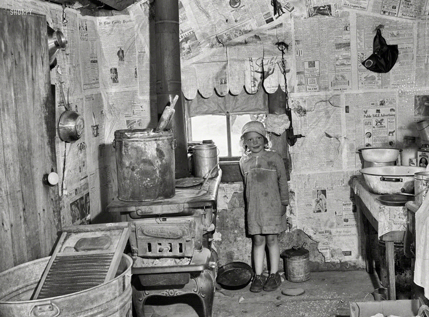 Kitchen of Ozarks cabin with newspapers on walls purchased for Lake of the Ozarks project