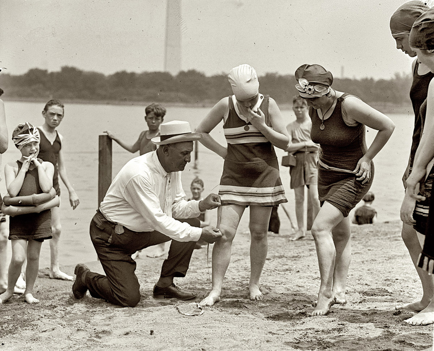 Photo of Washington policeman Bill Norton measuring the distance between knee and suit at the Tidal Basin bathing beach