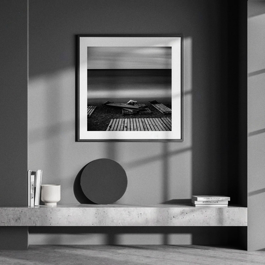 Black-and-white long exposure waterscape photographic print 40x40 cm «Three Buoys» framed on the wall to decorate dark interior of living space